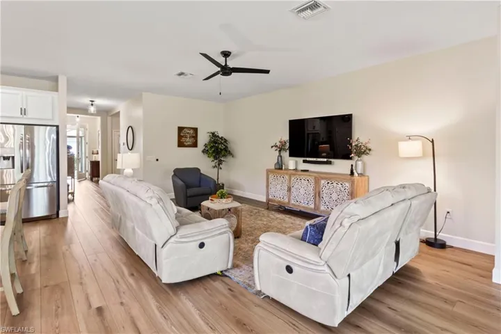 Living area featuring light wood-type flooring and ceiling fan