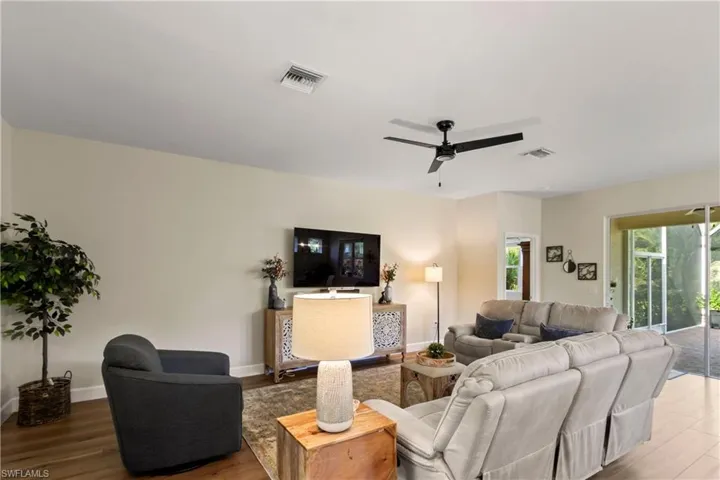 Living room featuring wood finished floors and a ceiling fan