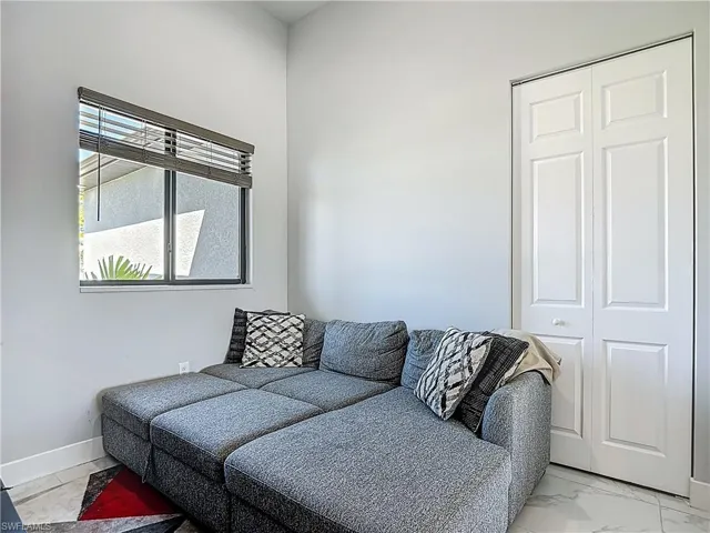 Living room with light marble finish flooring and baseboards