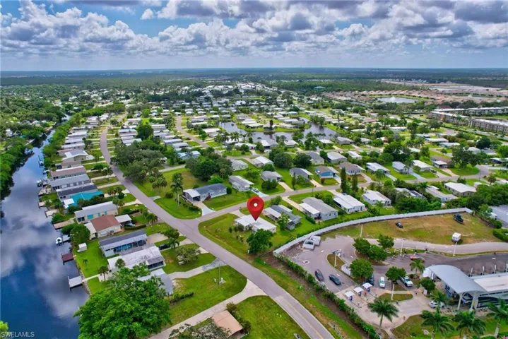 View of property location with a nearby body of water and nearby suburban area