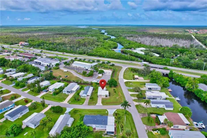 View of property location featuring a heavily wooded area and nearby suburban area