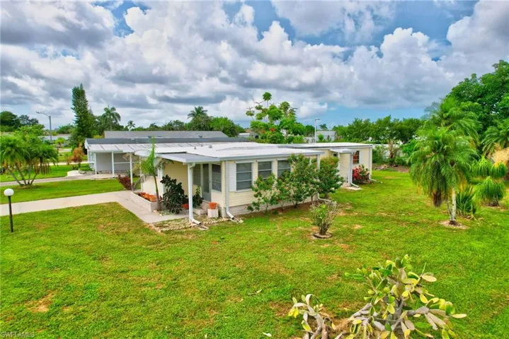 View of front of home featuring a front yard and driveway