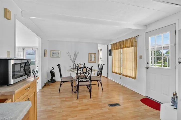 Dining space featuring light wood-style floors and beam ceiling