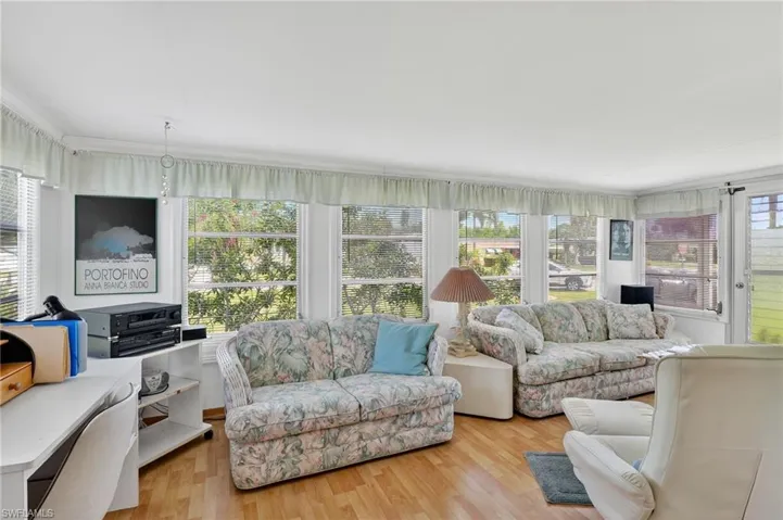 Living area featuring light wood-style floors and ornamental molding