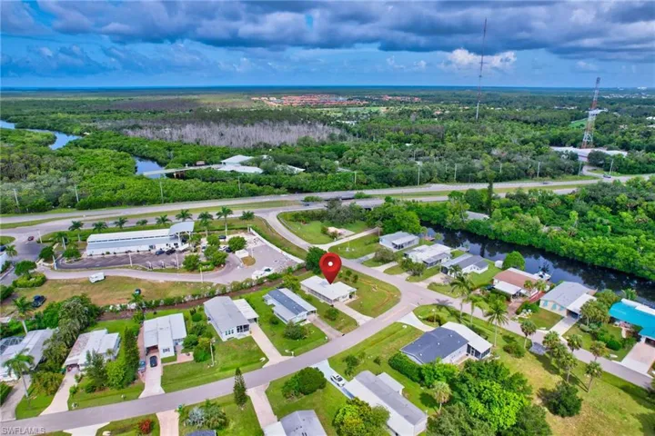 Aerial overview of property's location with a nearby body of water and nearby suburban area