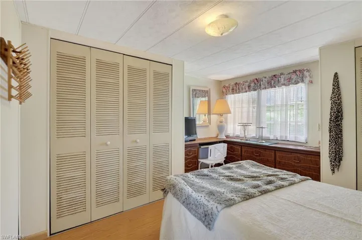 Bedroom with light wood-type flooring and a closet