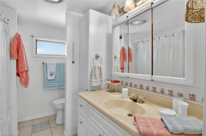 Full bathroom featuring vanity and tile patterned flooring