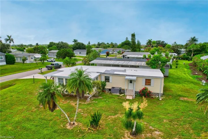 Rear view of house with a yard, a residential view, and entry steps