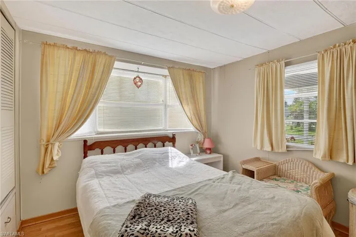 Bedroom with wood finished floors and baseboards