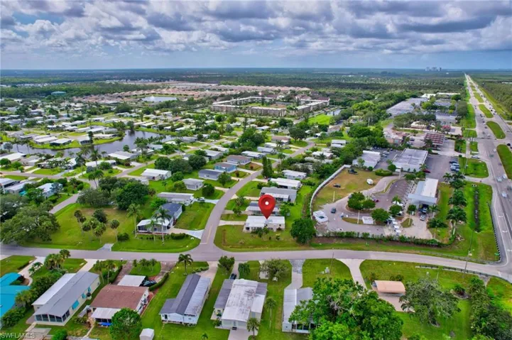 Aerial view of property's location featuring a large body of water and nearby suburban area