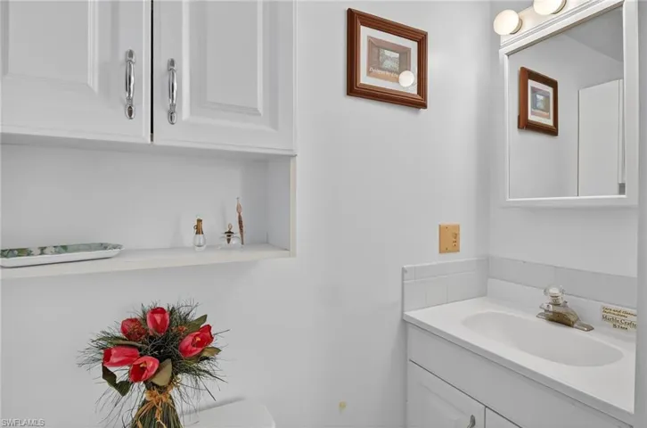 Half bathroom with vanity and toilet