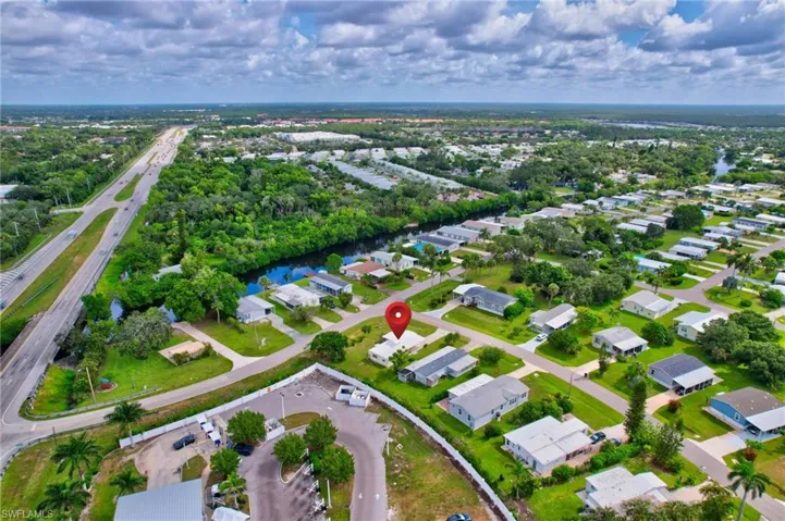 Aerial overview of property's location featuring nearby suburban area and a large body of water