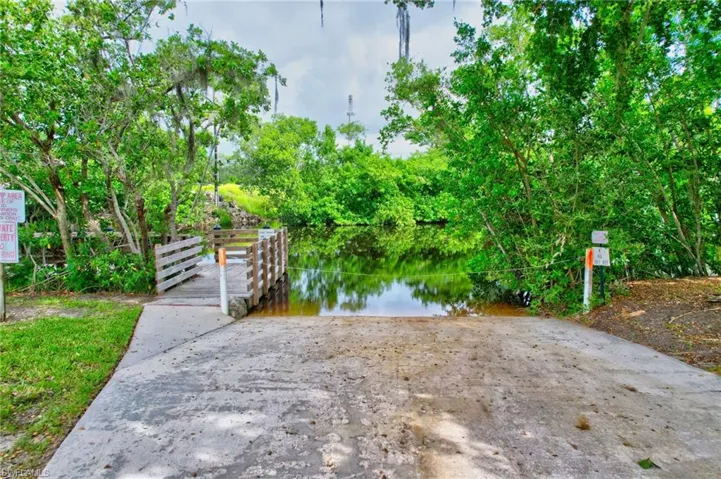 Dock area featuring a boat ramp and a water view