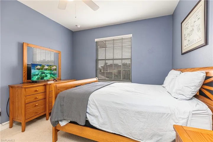 Bedroom featuring ceiling fan and light colored carpet