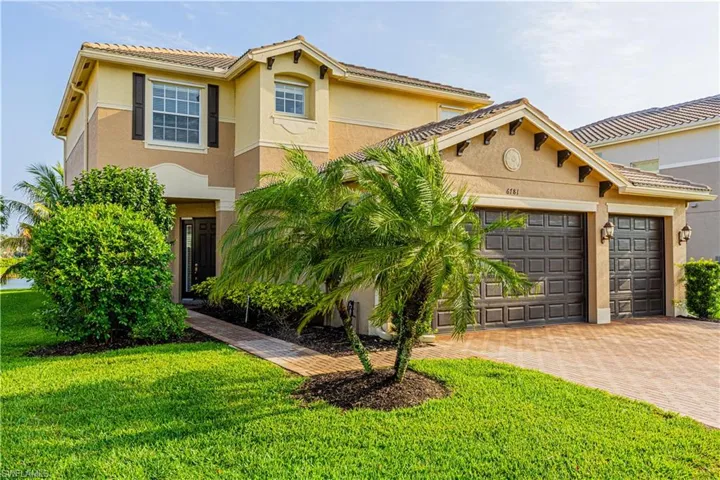 Mediterranean / spanish-style house featuring a garage and a front lawn