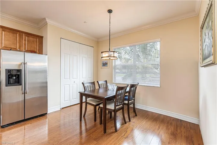 Dining area featuring ornamental molding and light hardwood / wood-style floors