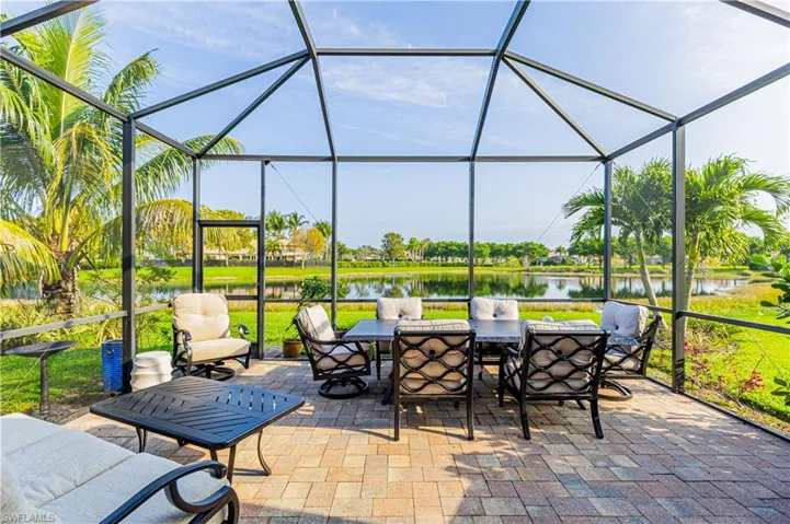 Sunroom featuring a water view