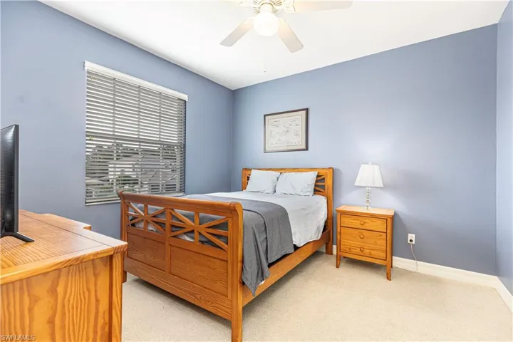 Bedroom featuring light carpet and ceiling fan