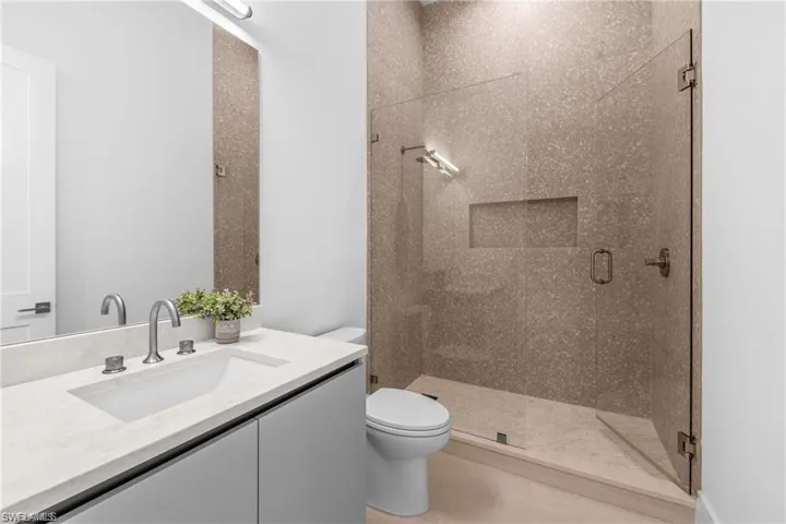 Full bath with a stall shower and vanity