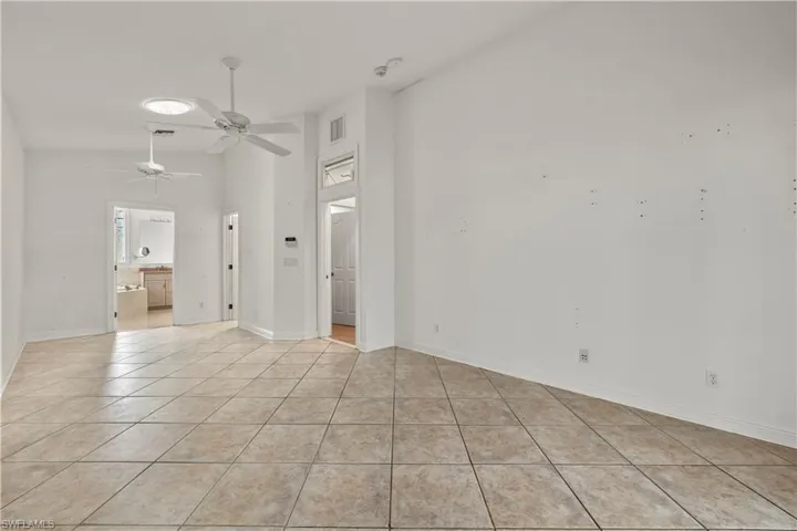 Unfurnished room with ceiling fan and light tile patterned floors