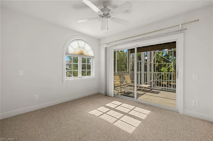 Spare room with light colored carpet and ceiling fan