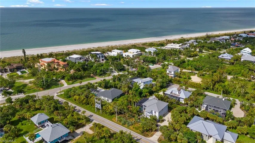 Aerial view featuring a beach view and a water view