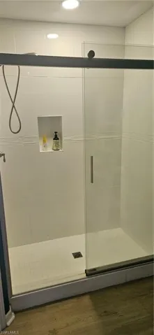 Bathroom featuring a stall shower and wood finished floors