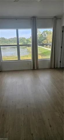 Spare room featuring wood finished floors