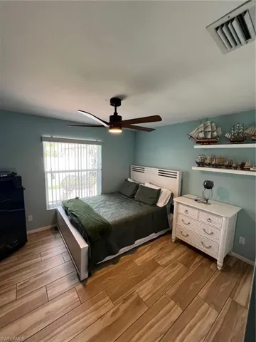 Bedroom featuring wood finish floors and a ceiling fan