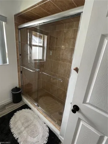 Full bath featuring a shower stall