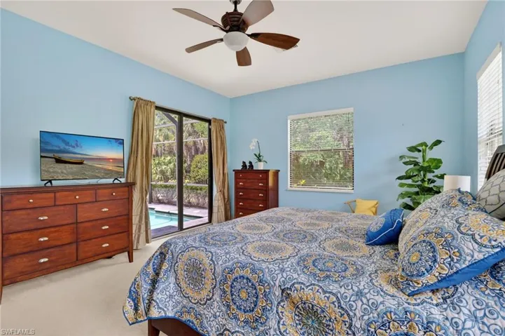 Primary Bedroom with views of pool & nature preserve