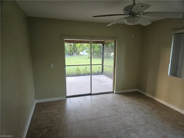Unfurnished room featuring ceiling fan and tile patterned flooring