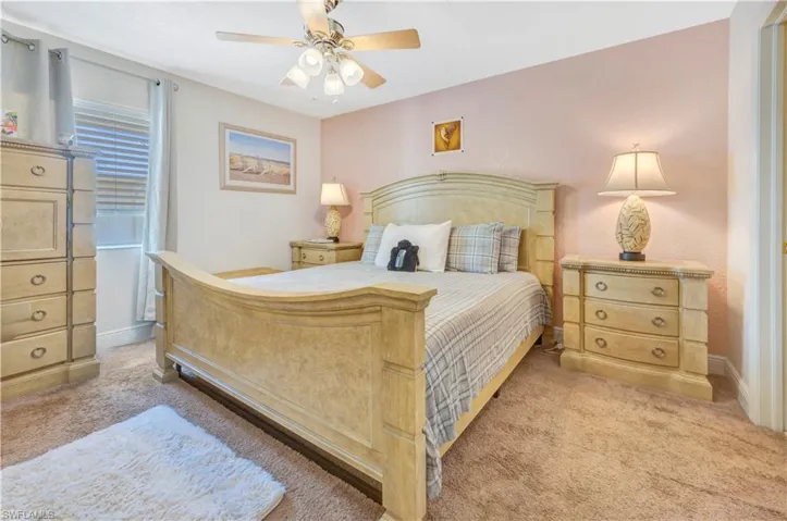 Carpeted bedroom with ceiling fan