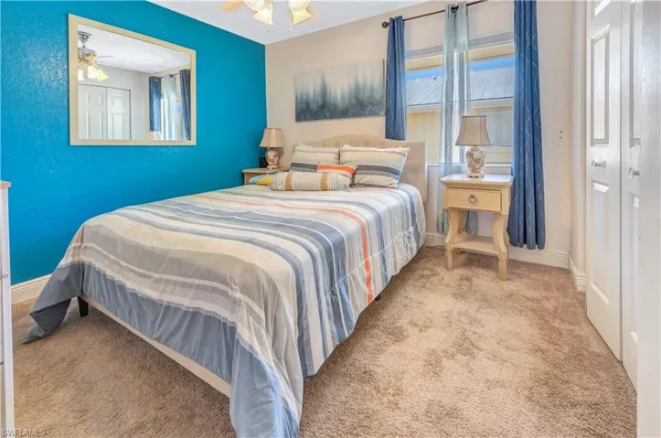 Bedroom with ceiling fan and carpet floors