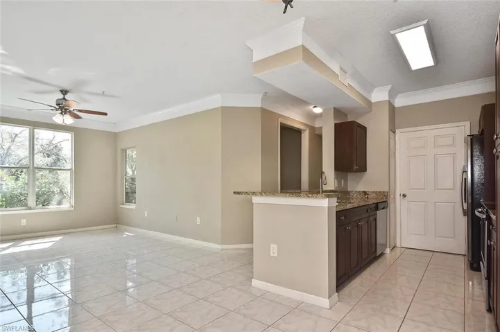 Neutral colors and high-gloss tile enlarge the great room concept!