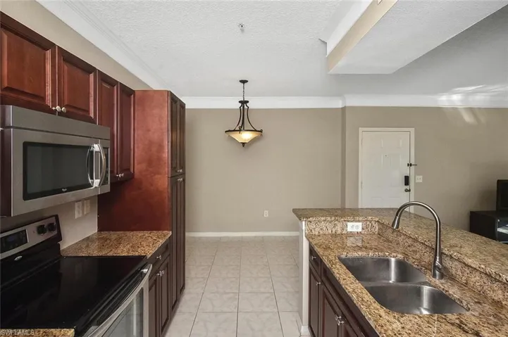 Rich wood cabinets complement the durable and elegant granite counters.