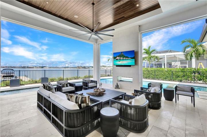 Outdoor Living area with fireplace, one touch electric screens and Hurricane protection