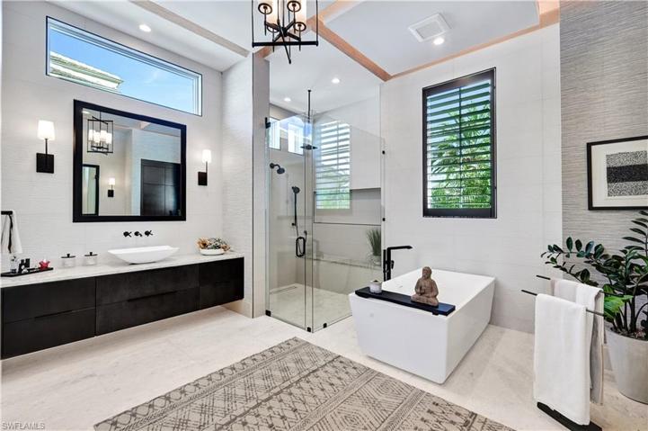 His and her sinks and commodes. Walk-in glass shower, beautiful soaking tub