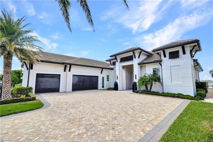 Beautiful Home with 3 car garage, Bahama shutters, Flat Tile Roof, Paver Drive, Tropical Landscaping, Landscape Lighting, Hurricane doors and windows