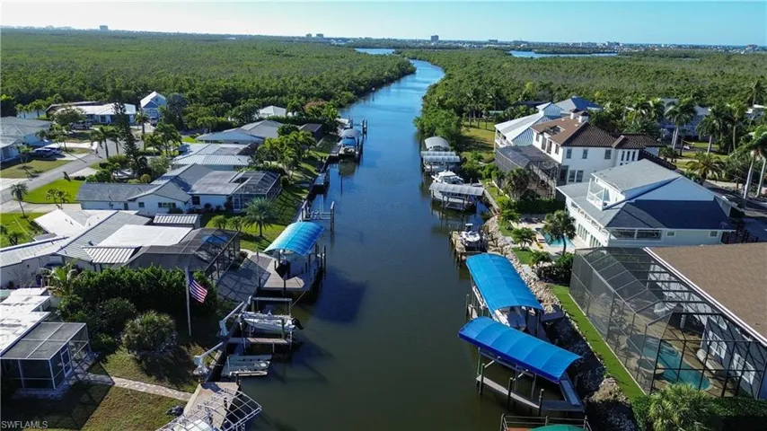 Drone / aerial view of a large body of water and a forest