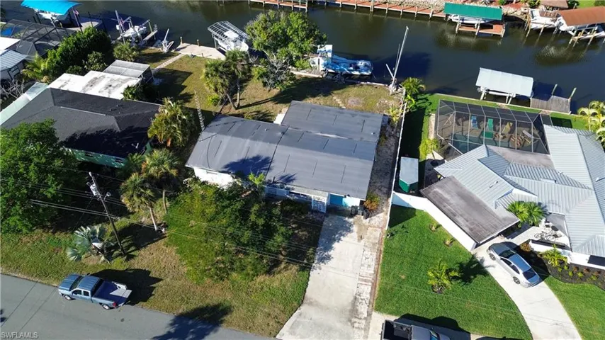 Aerial perspective of suburban area featuring a large body of water