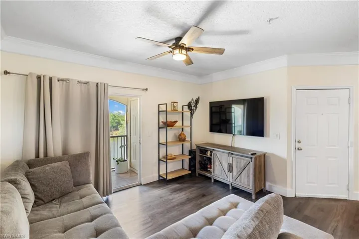 Sliding door to the balcony on left - front entry door on the right.
