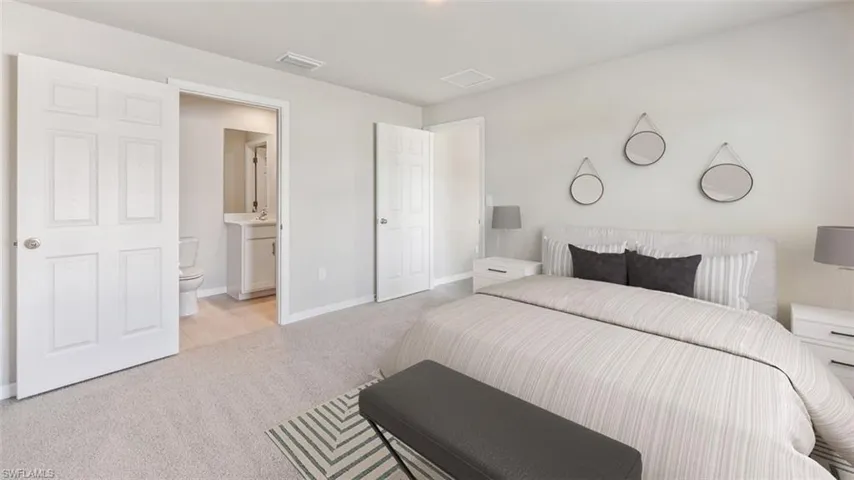 Carpeted bedroom with connected bathroom