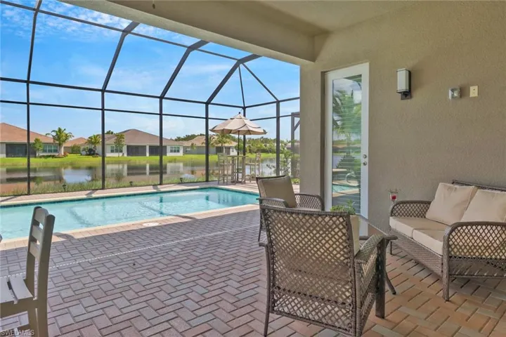 View of pool featuring a patio area and a lanai