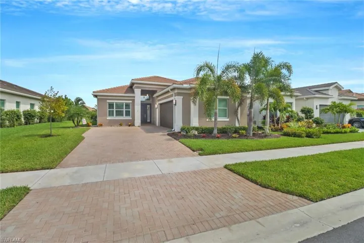 Mediterranean / spanish home with a garage and a front lawn