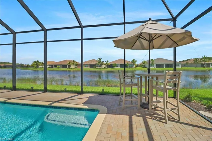 View of swimming pool with a patio area and a water view