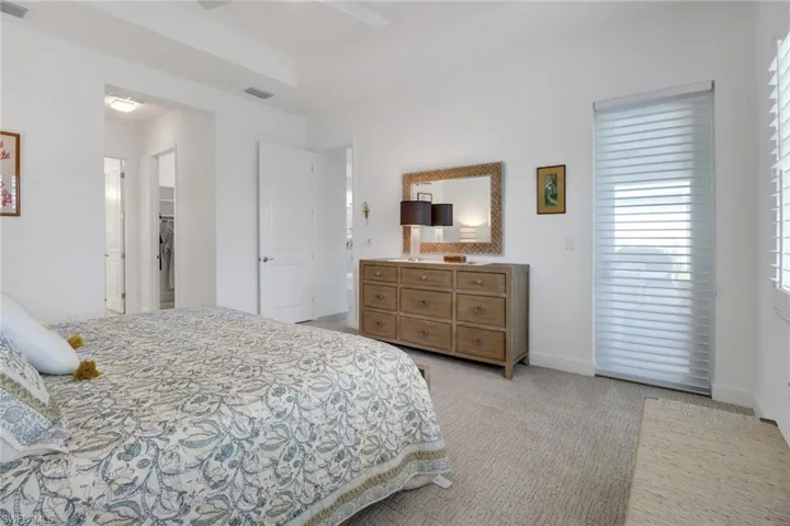 Carpeted bedroom with ceiling fan