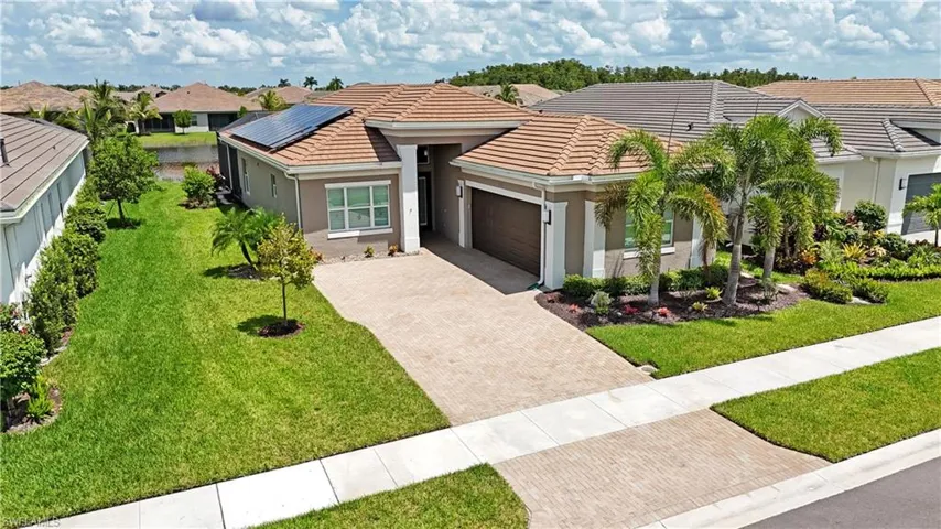 View of front of house featuring a garage and a front lawn