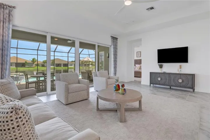 Living room featuring light tile patterned flooring and ceiling fan