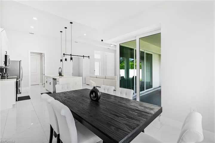 Open-concept living space with white tile flooring